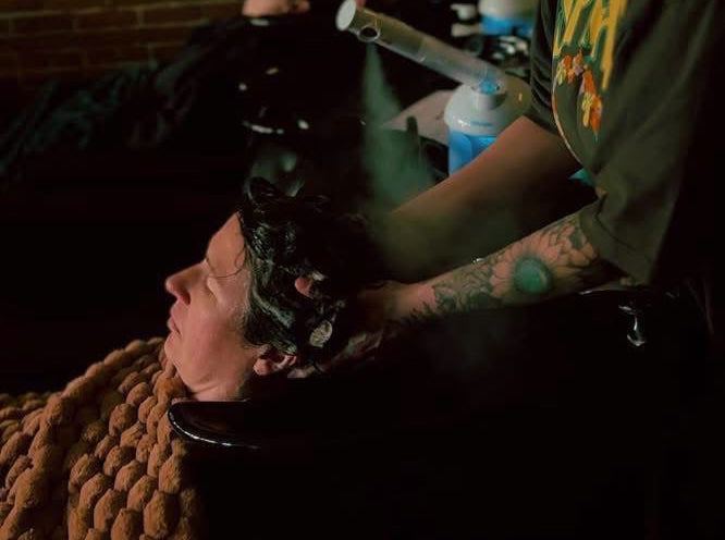 Person getting hair washed and scalp massage.